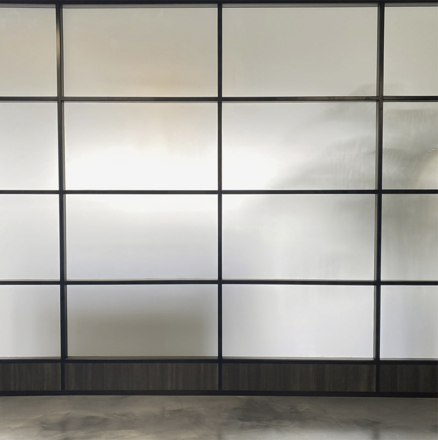 Flex Series segmented glass wall with privacy film and laminate bottom electrical data power channel