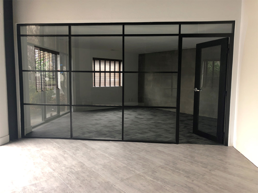 Glass wall with multiple transoms and black aluminum frame finish