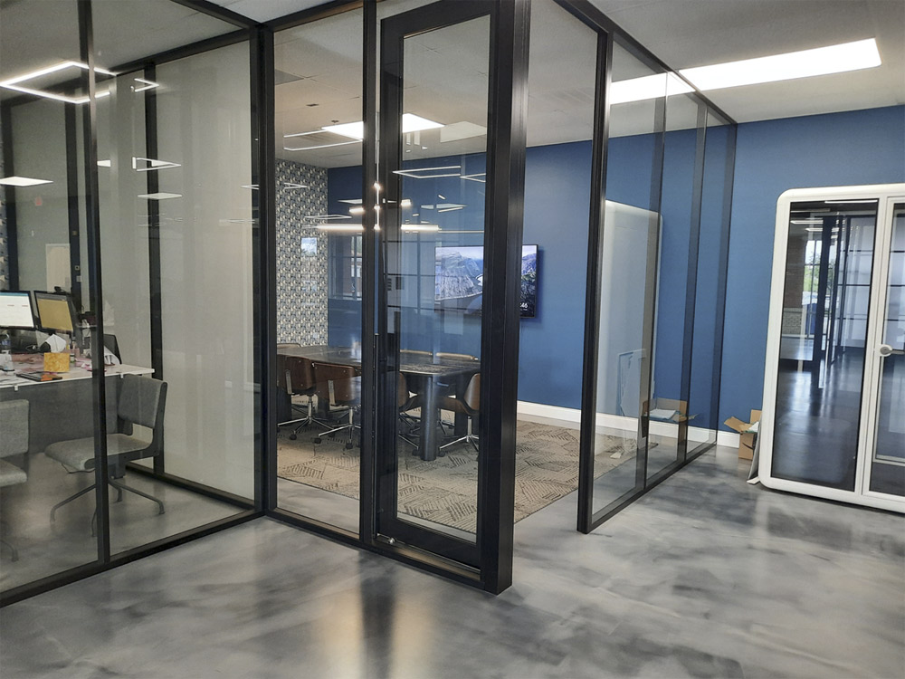 NxtWall glass conference room with fabric side walls and black aluminum frame swing door