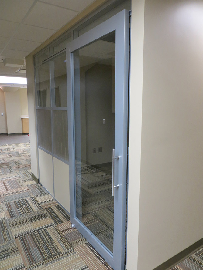 Aluminum framed sliding glass door office with designer 3form wall panels