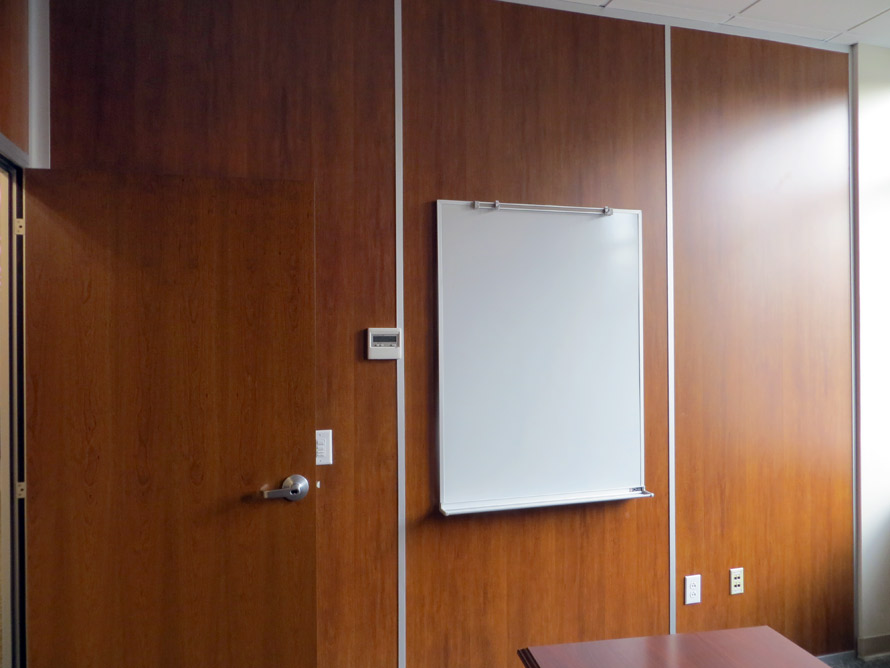 Solid wood panel walls with mounted whiteboard