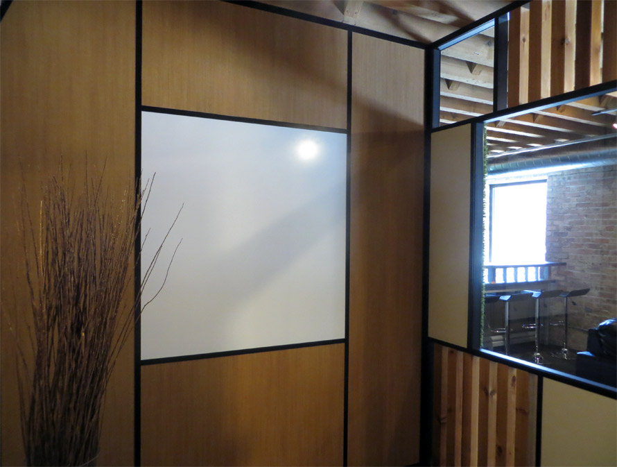 Integrated whiteboard wall with black extrusions and glazing bead
