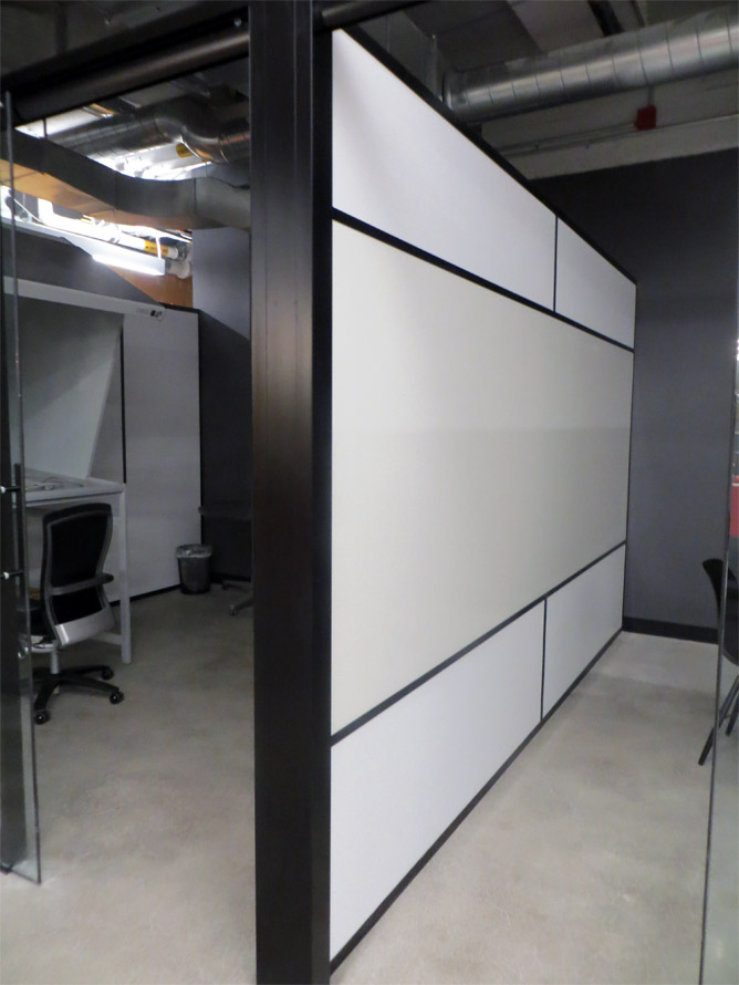 Freestanding offices with black extrusions and whiteboard demising wall