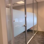 Glass office with sliding glass door and privacy opaque window film
