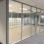 Glass walls with solid full-height wall panels and sliding glass door