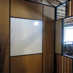 Integrated whiteboard wall with black wall trim and glazing bead