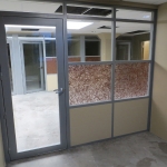 Offices with aluminum framed glass insert swing doors