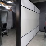 Freestanding offices with black extrusions and whiteboard demising wall