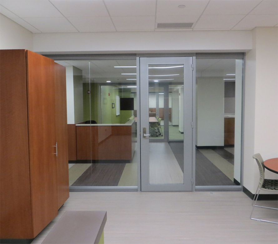 Centered glass office front with aluminum door frames and seamless glass
