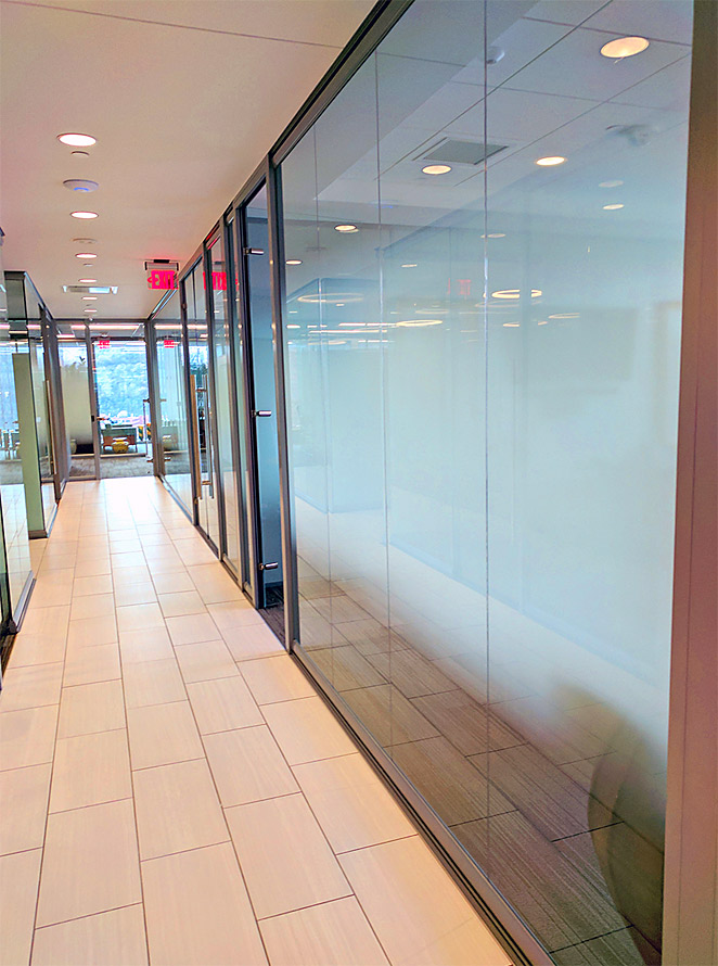 Glass office walls with applied decorative window film
