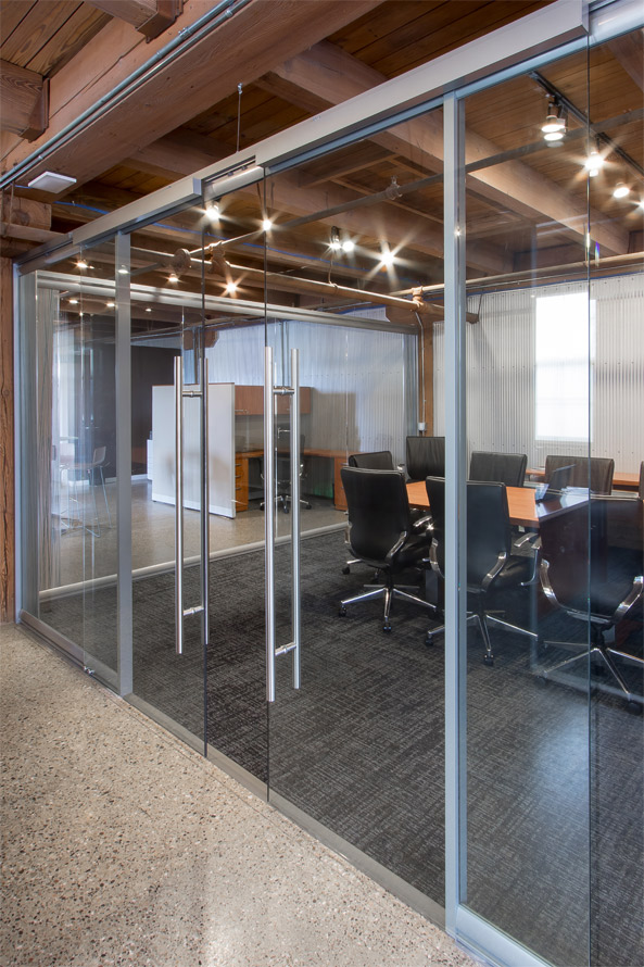 Glass conference room with double sliding glass doors, soft open/close door hardware