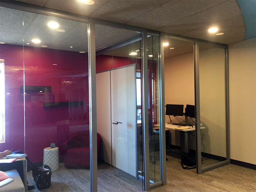 Glass offices with seamless glass return wall (wingback) and butt-joint clerestory