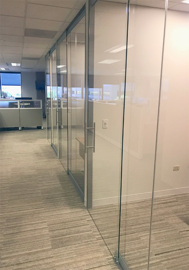 Floor-to-ceiling glass offices with sliding glass doors