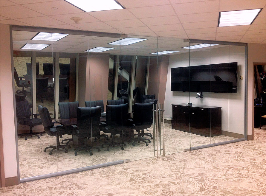 Double swing frameless glass doors on glass conference room walls