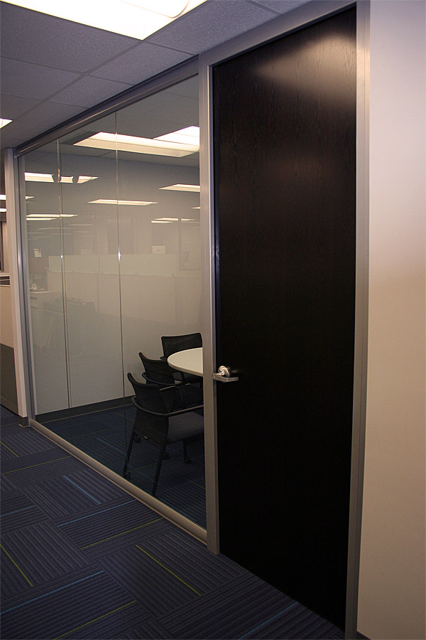 Glass meeting room with solid wood veneer door