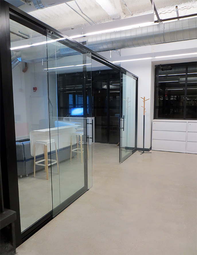 Glass office front with double glass sliding doors