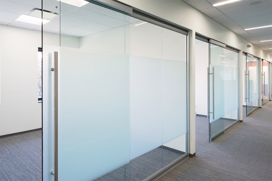 Glass office walls with soft-closing sliding glass door hardware