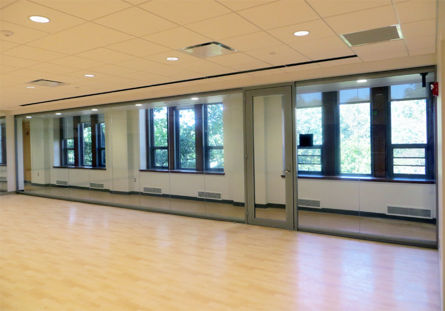 Glass seamless multi-purpose room with hardwood flooring View series interior walls