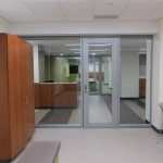 Centered glass office front with aluminum door frames and seamless glass