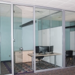 Full height frameless glass swing door Flex Series office with View Series open corner