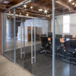 Glass conference room with double sliding glass doors, soft open/close door hardware