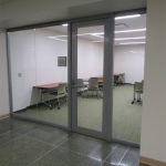 Center mounted seamless glass office (Higher Education)
