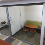 Full height sliding glass office doors in College University wall application