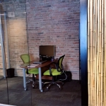 Glass fishbowl office View series with bamboo reeds wall panel