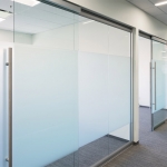 Glass office walls with soft-closing sliding glass door hardware