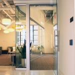 View full-height glass offices and frameless glass door