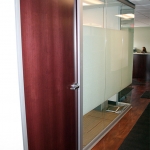 Wood veneer swing door on View series glass office