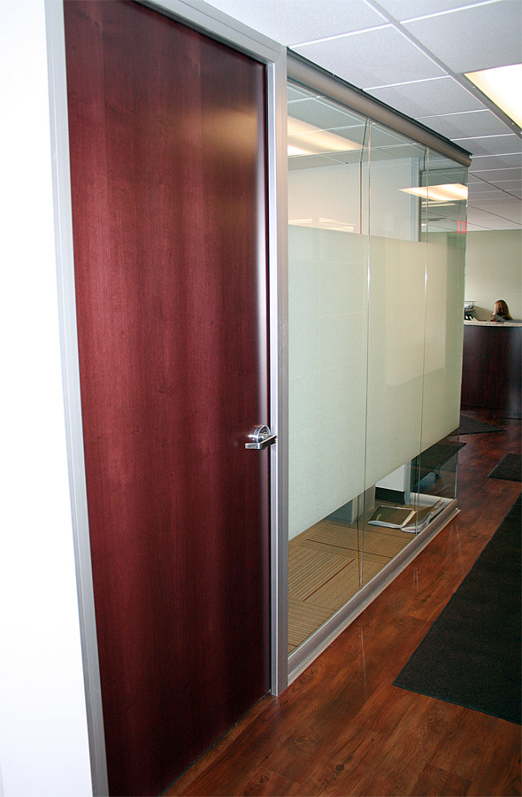 Wood veneer swing door on View series glass office