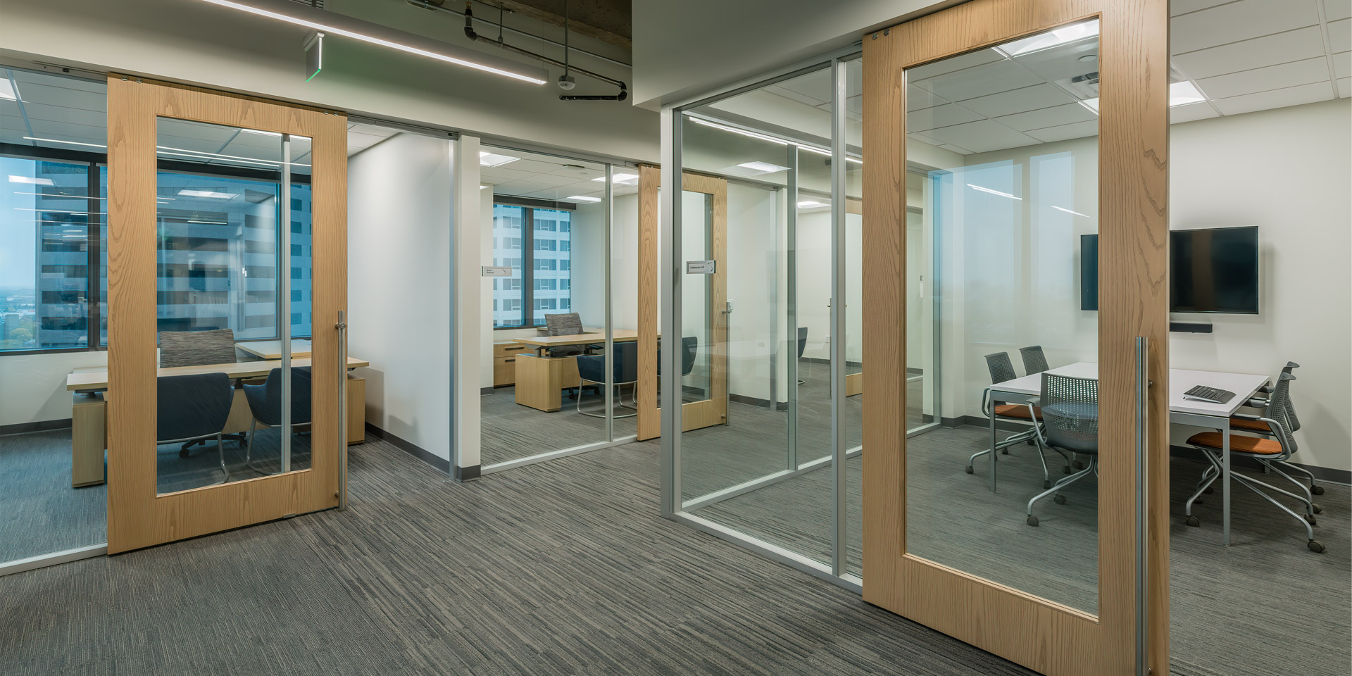 Flex Series glass offices with wood frame sliding doors