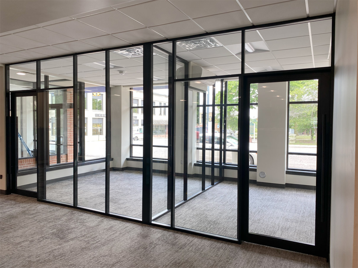 Glass offices with glass sidewalls and black frame color field-fit demountable walls #1643