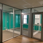 Flex glass fronts with powered kickplate glass side walls