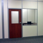 Solid Office Walls with Sliding Glass Teller Window