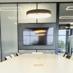Conference area with Formica Blackened Steel laminate finish decorative wall panels and glass side walls.