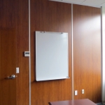 Solid wood panel walls with mounted whiteboard