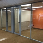 Glass office wall system with integrated whiteboard sidewall