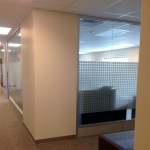 Glass office wall with square pattern frosted film