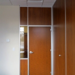 Office with solid wood panels matching door and glass sidelight