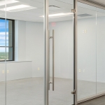 Modern glass walls with frameless swing glass door