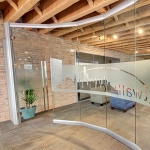 Curved glass conference room wall with 3M window film