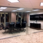 Double swing frameless glass doors on glass conference room walls #0579