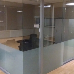 Glass office with frameless glass sliding door